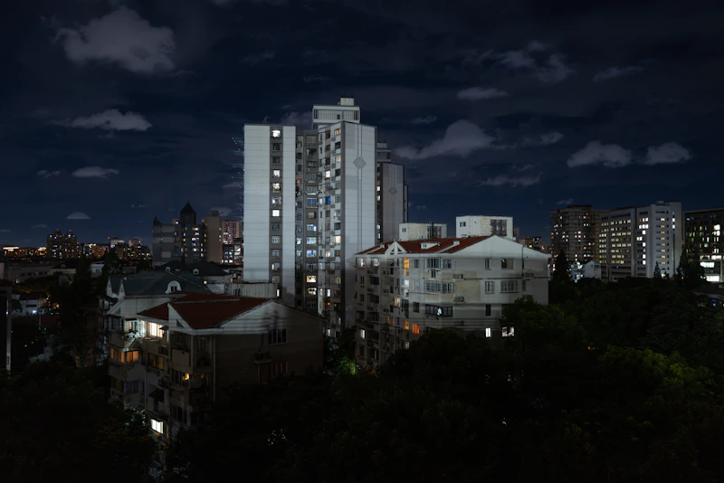 City skyline with illuminated buildings at night.